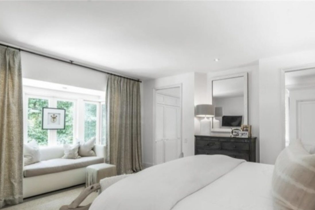 Serene bedroom with window seat and leopard print drapery