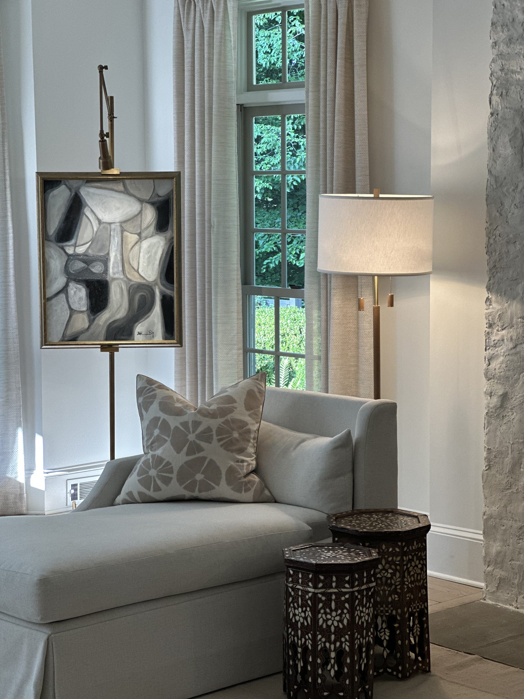 Reading corner with chaise, easel-hung abstract art and inlaid Moorish tables