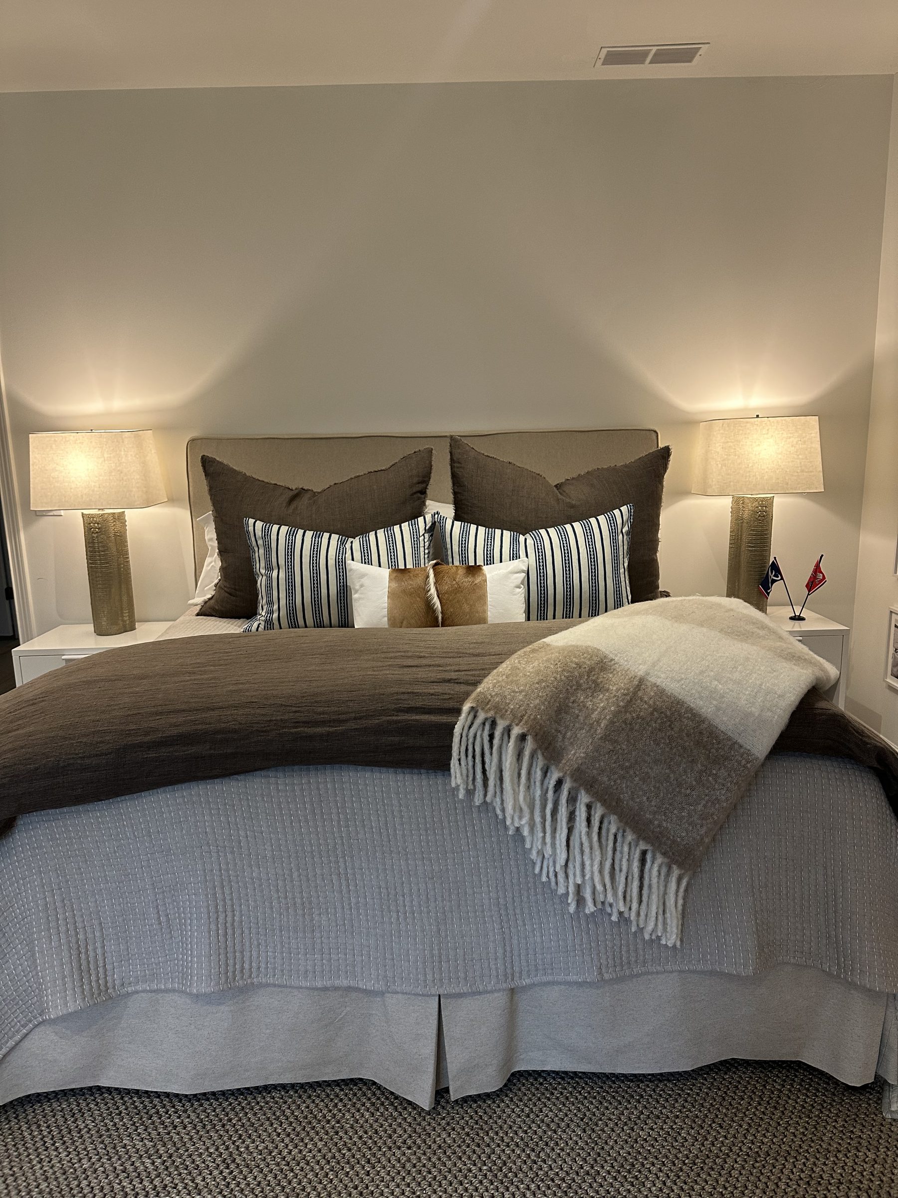 Guest bedroom with layered linen bedding and springbok hide pillow